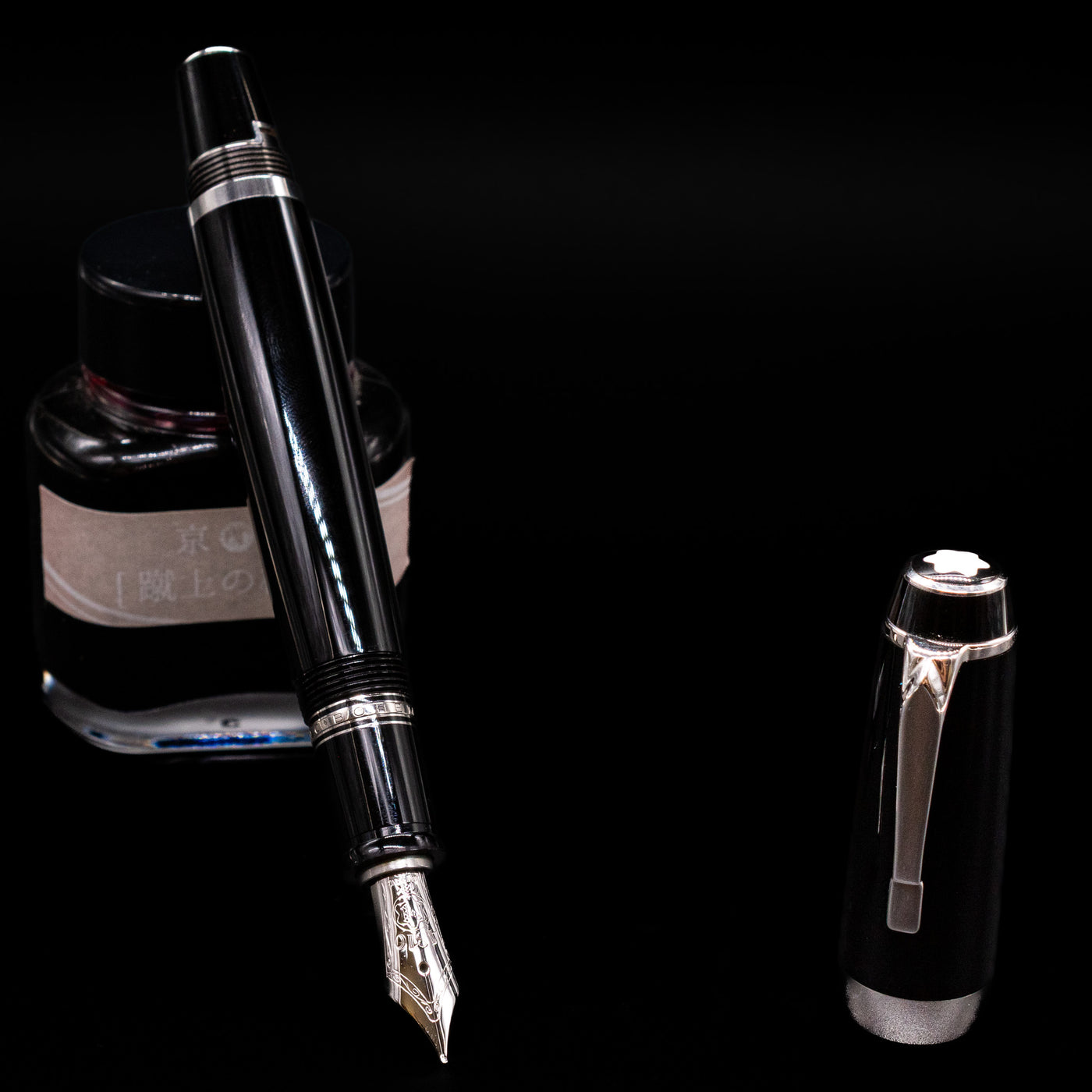 Montblanc Boheme Jumbo Large Fountain Pen - Preowned leaning on an ink bottle uncapped showcasing the detailing on the nib.