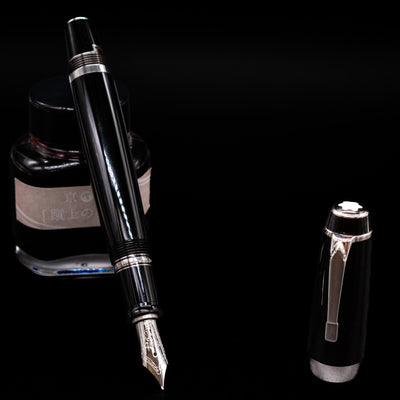 Montblanc Boheme Jumbo Large Fountain Pen - Preowned leaning on an ink bottle uncapped showcasing the detailing on the nib.