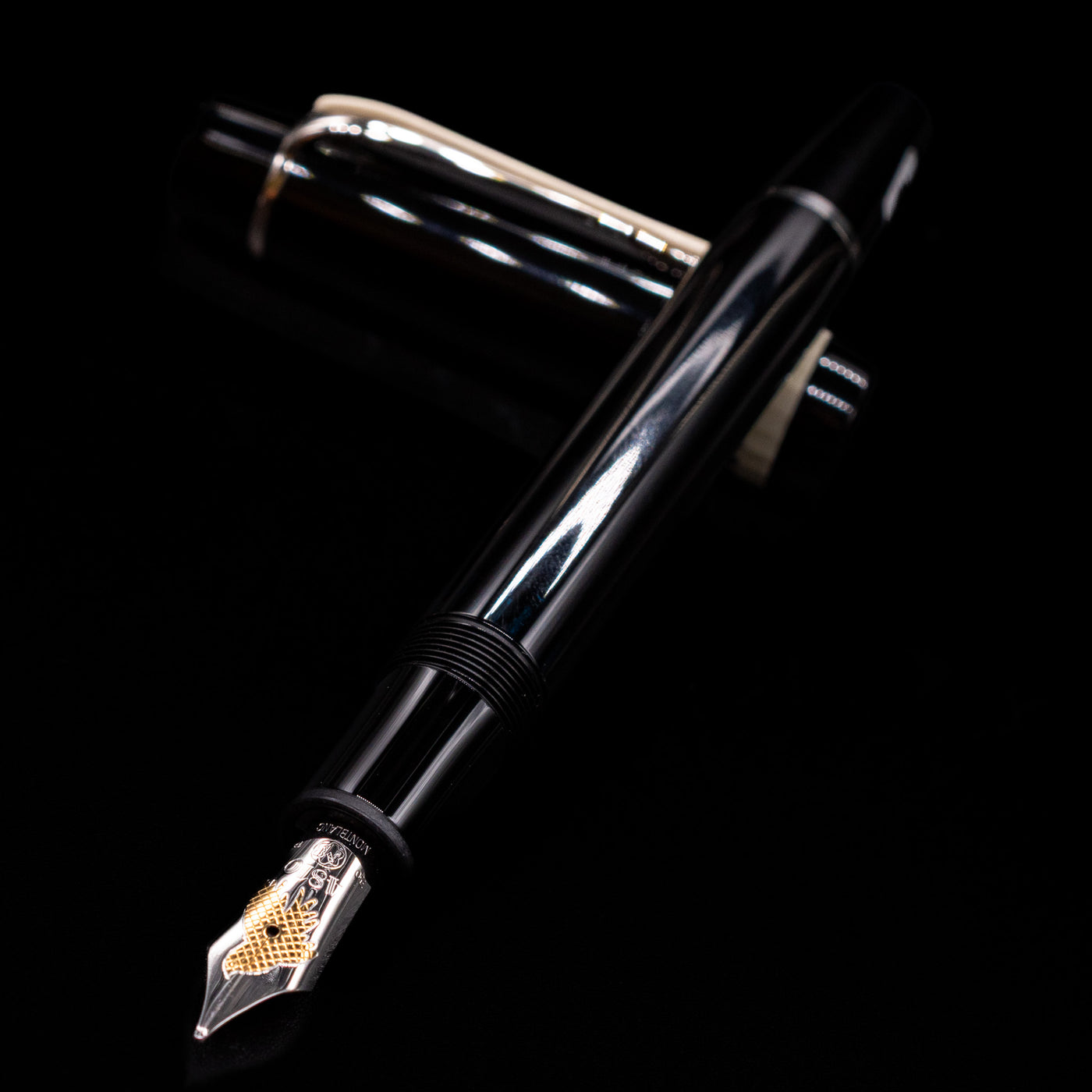 Montblanc Donation Herbert von Karajan Fountain Pen - Preowned laying across its own cap, crossed, with a focus on the nib.