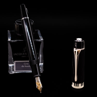 Montblanc Donation Herbert von Karajan Fountain Pen - Preowned leaning on an ink bottle uncapped showcasing the detailing on the nib.