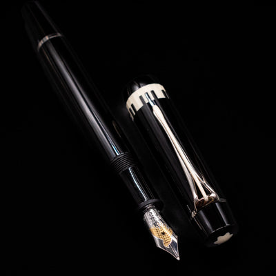 A full view of the Montblanc Donation Herbert von Karajan Fountain Pen - Preowned uncapped, with its cap laying next to the pen. 