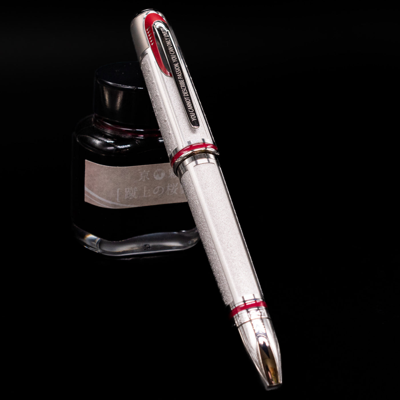Montblanc Great Characters Enzo Ferrari Limited Edition 1898 Rollerball Pen - Preowned capped, leaning against an ink bottle. 
