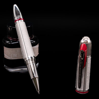 Montblanc Great Characters Enzo Ferrari Limited Edition 1898 Rollerball Pen - Preowned leaning on an ink bottle uncapped.