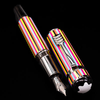 A full view of the Montblanc Great Characters The Beatles Special Edition Fountain Pen - Preowned uncapped, with its cap laying next to the pen. 