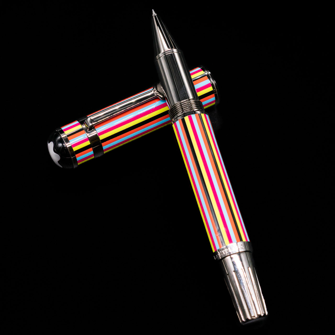 Montblanc Great Characters The Beatles Special Edition Rollerball Pen - Preowned laying on top of its cap in a crossed position showing full view of the entire uncapped pen.