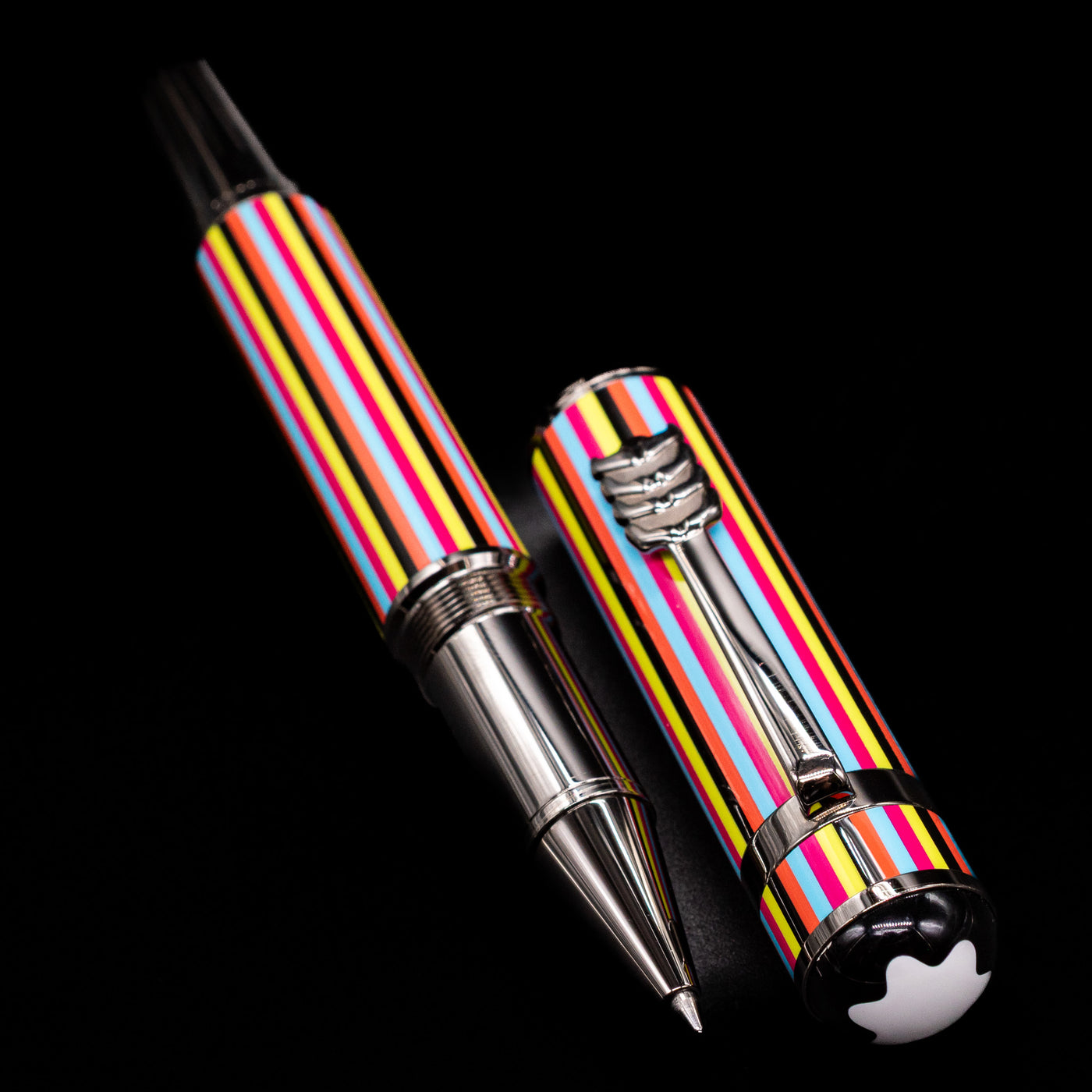 A full view of the Montblanc Great Characters The Beatles Special Edition Rollerball Pen - Preowned uncapped, with its cap laying next to the pen. 