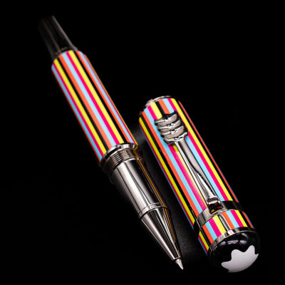 A full view of the Montblanc Great Characters The Beatles Special Edition Rollerball Pen - Preowned uncapped, with its cap laying next to the pen. 
