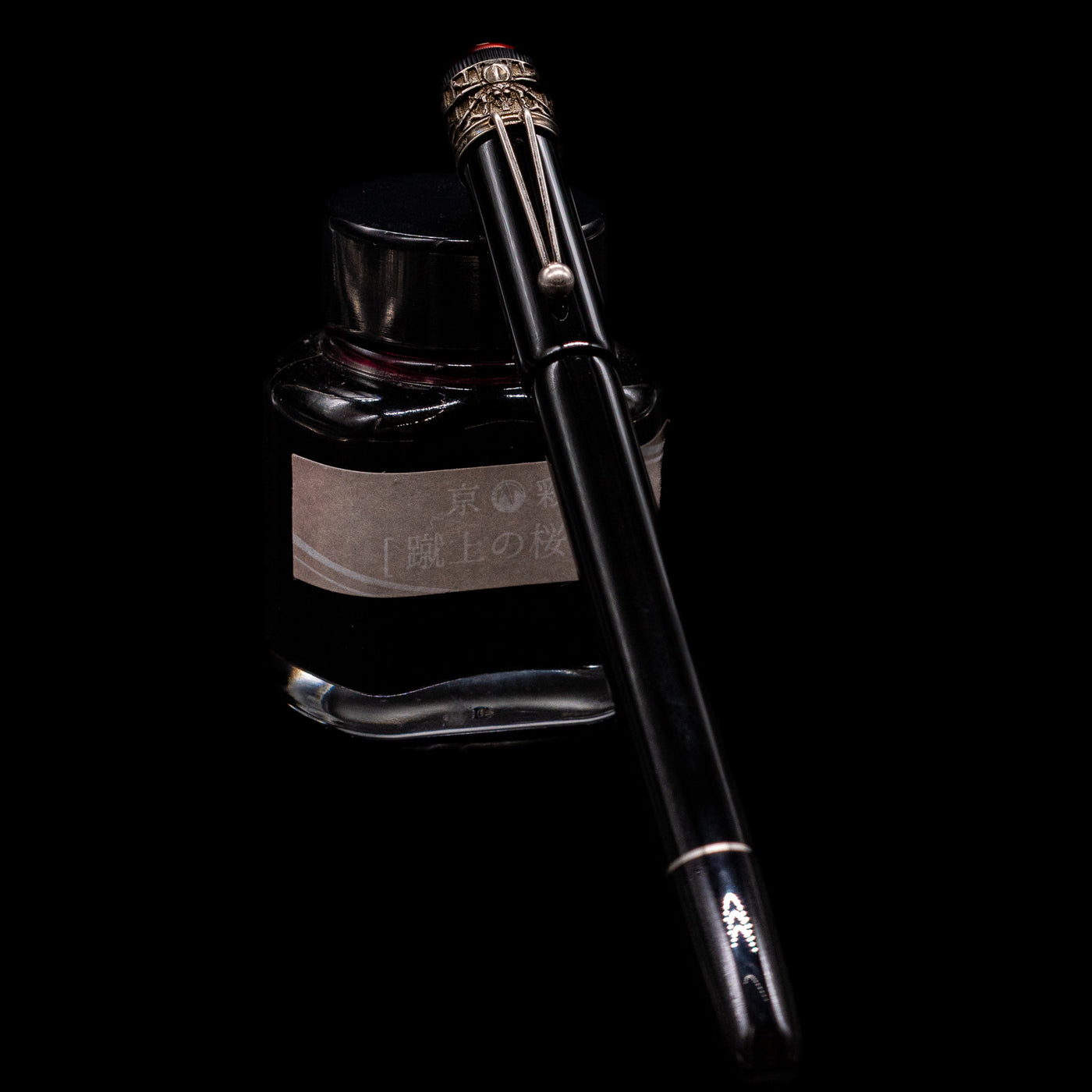 Montblanc Heritage Collection Metamorphosis Fountain Pen - Preowned capped, leaning against an ink bottle. 