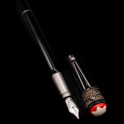 A full view of the Montblanc Heritage Collection Metamorphosis Fountain Pen - Preowned uncapped, with its cap laying next to the pen. 