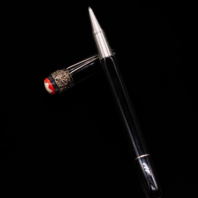 Montblanc Heritage Collection Metamorphosis Rollerball Pen - Preowned laying on top of its cap in a crossed position showing full view of the entire uncapped pen.