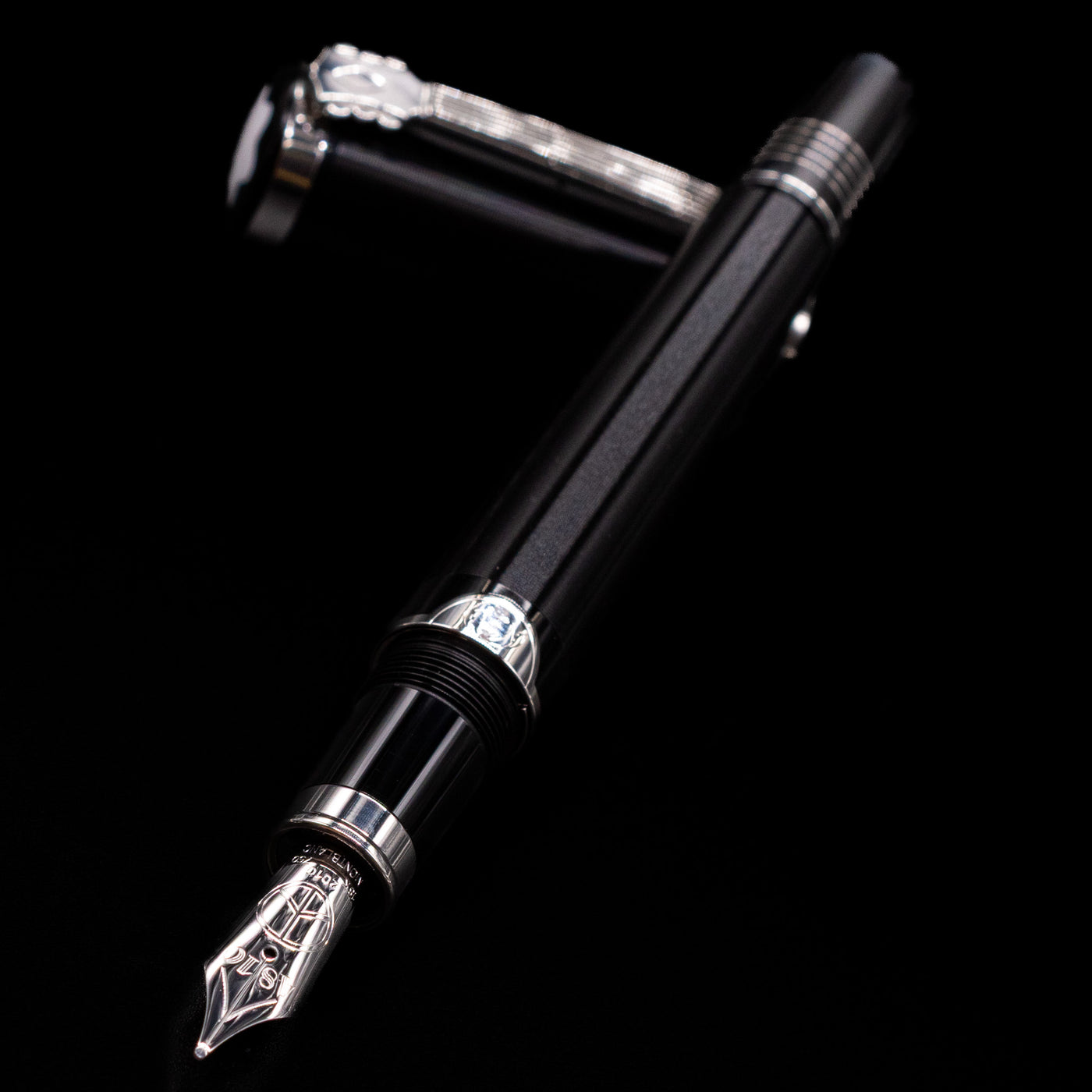 Montblanc John Lennon Special Edition Fountain Pen - Preowned laying across its own cap, crossed, with a focus on the nib.