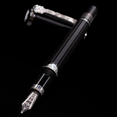 Montblanc John Lennon Special Edition Fountain Pen - Preowned laying across its own cap, crossed, with a focus on the nib.