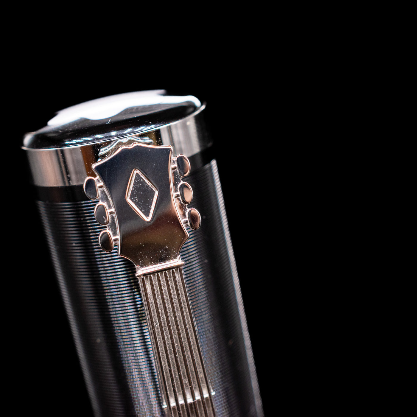 A macro shot of the top of the cap with the guitar clip detailing on the Montblanc John Lennon Special Edition Fountain Pen - Preowned.