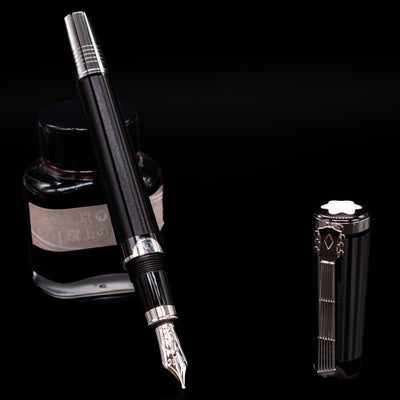 Montblanc John Lennon Special Edition Fountain Pen - Preowned leaning on an ink bottle uncapped showcasing the detailing on the nib.