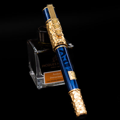 Montblanc Masters of Art Homage to Gustav Klimt Limited Edition 4810 Rollerball Pen - Preowned capped, leaning agains an ink bottle.