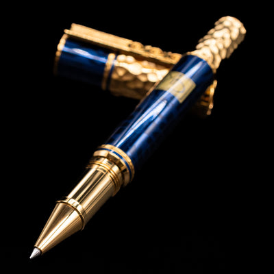 Montblanc Masters of Art Homage to Gustav Klimt Limited Edition 4810 Rollerball Pen - Preowned laying across its own cap, crossed, with a focus on the tip.