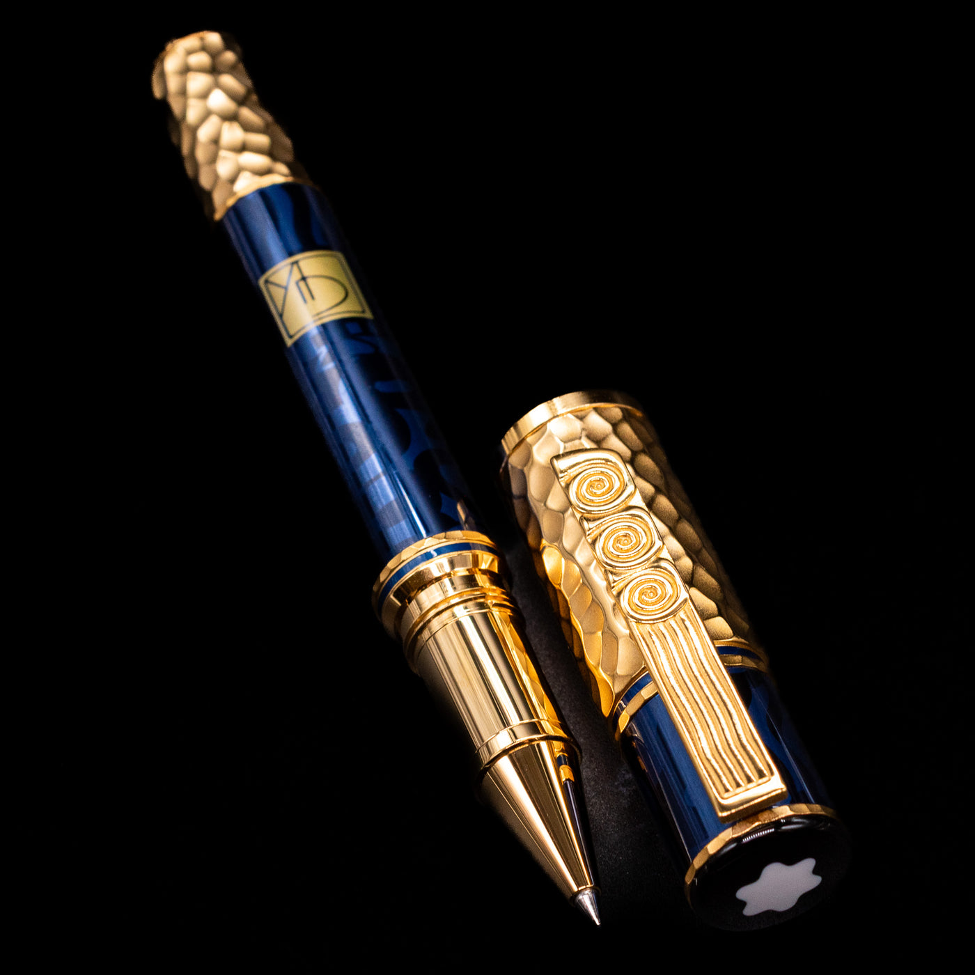  A full view of the Montblanc Masters of Art Homage to Gustav Klimt Limited Edition 4810 Rollerball Pen - Preowned uncapped, with its cap laying next to the pen. 
