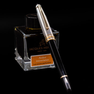 Montblanc Meisterstuck 144DS Solitaire Doue Fountain Pen - Preowned capped, leaning against an ink bottle. 