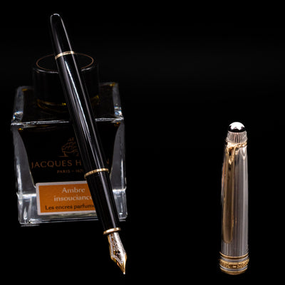Montblanc Meisterstuck 144DS Solitaire Doue Fountain Pen - Preowned leaning on an ink bottle uncapped showcasing the detailing on the nib.