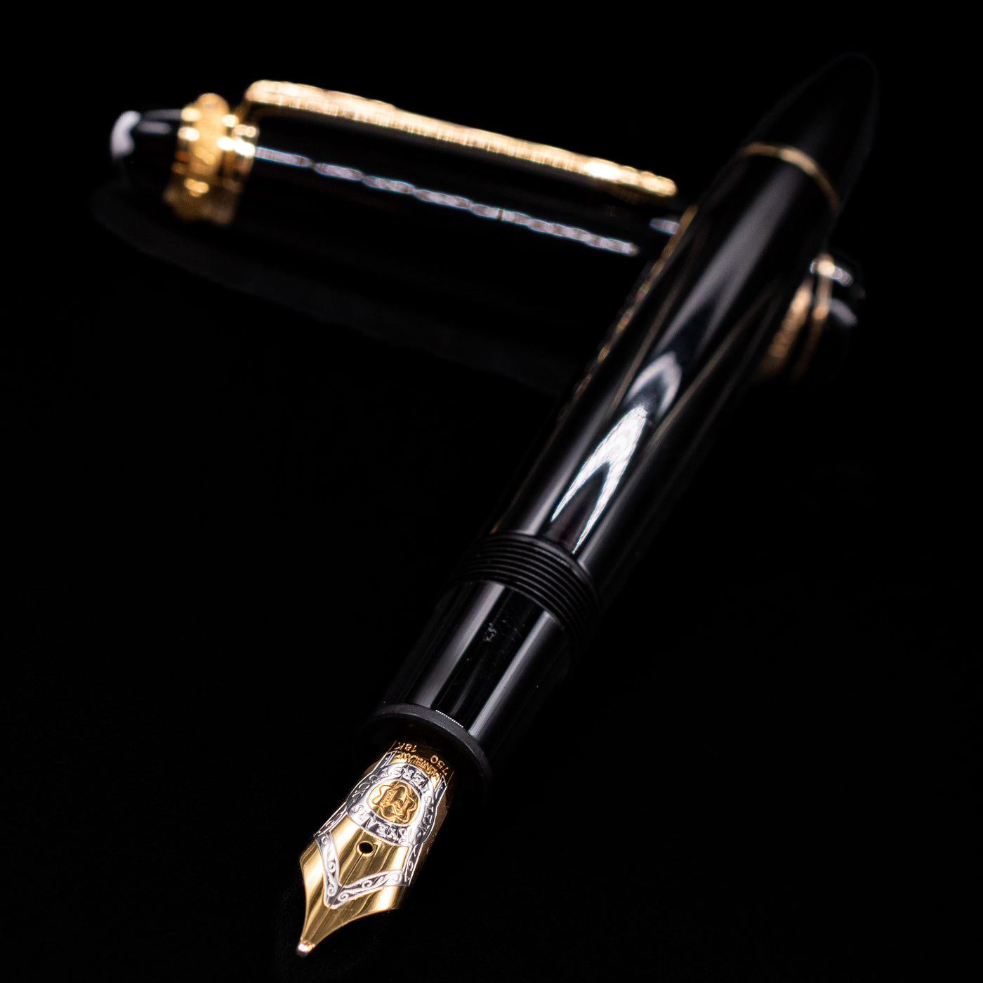 Montblanc Meisterstuck 146 75th Anniversary Special Edition LeGrand Fountain Pen - Preowned laying across its own cap, crossed, with a focus on the nib.
