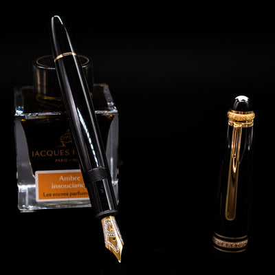 Montblanc Meisterstuck 146 75th Anniversary Special Edition LeGrand Fountain Pen - Preowned leaning on an ink bottle uncapped showcasing the detailing on the nib.