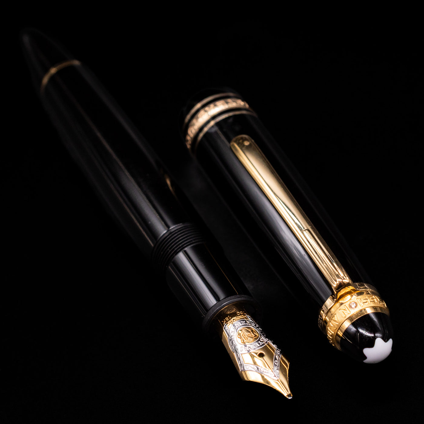 A full view of the Montblanc Meisterstuck 146 75th Anniversary Special Edition LeGrand Fountain Pen - Preowned uncapped, with its cap laying next to the pen. 
