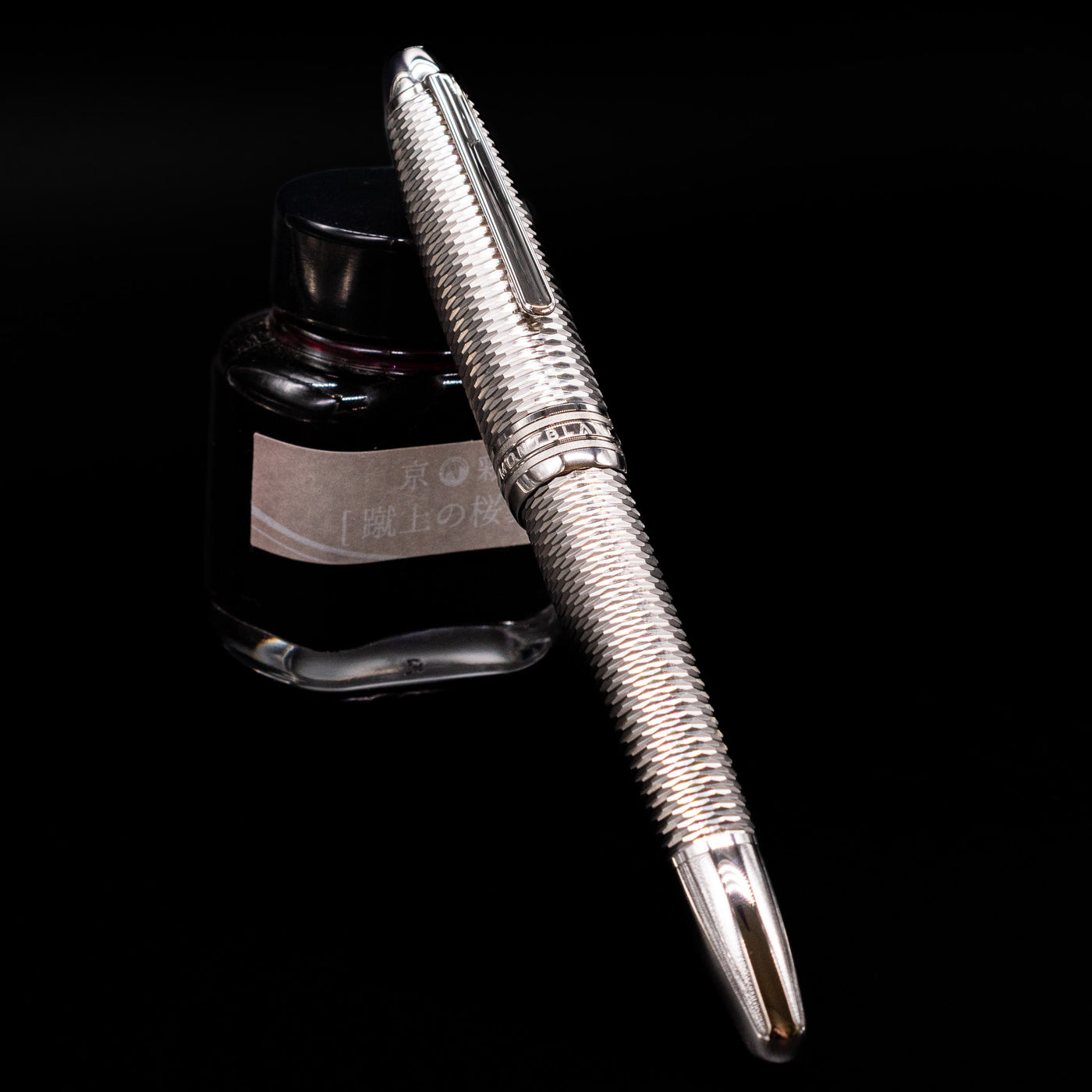 Montblanc Meisterstuck 146 Solitaire Geometry City Edition LeGrand Fountain Pen - New York capped, leaning against an ink bottle. 
