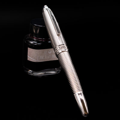 Montblanc Meisterstuck 146 Solitaire Geometry City Edition LeGrand Fountain Pen - New York capped, leaning against an ink bottle. 
