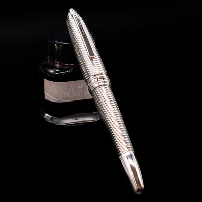 Montblanc Meisterstuck 146 Solitaire Geometry City Edition LeGrand Fountain Pen - Tokyo capped, leaning against an ink bottle. 