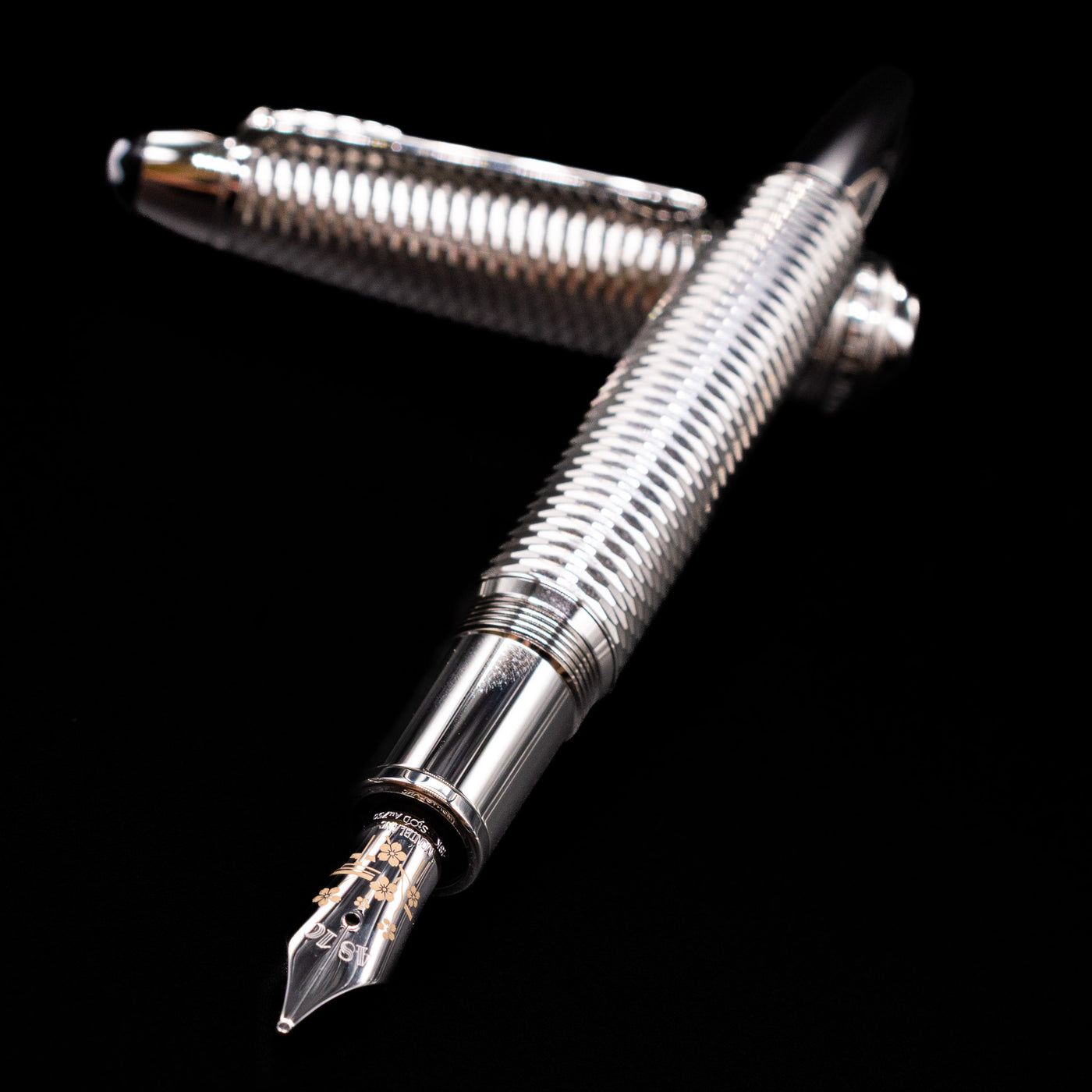 Montblanc Meisterstuck 146 Solitaire Geometry City Edition LeGrand Fountain Pen - Tokyo laying across its own cap, crossed, with a focus on the nib.