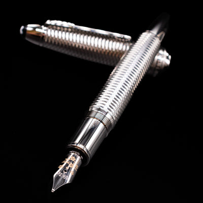 Montblanc Meisterstuck 146 Solitaire Geometry City Edition LeGrand Fountain Pen - Tokyo laying across its own cap, crossed, with a focus on the nib.