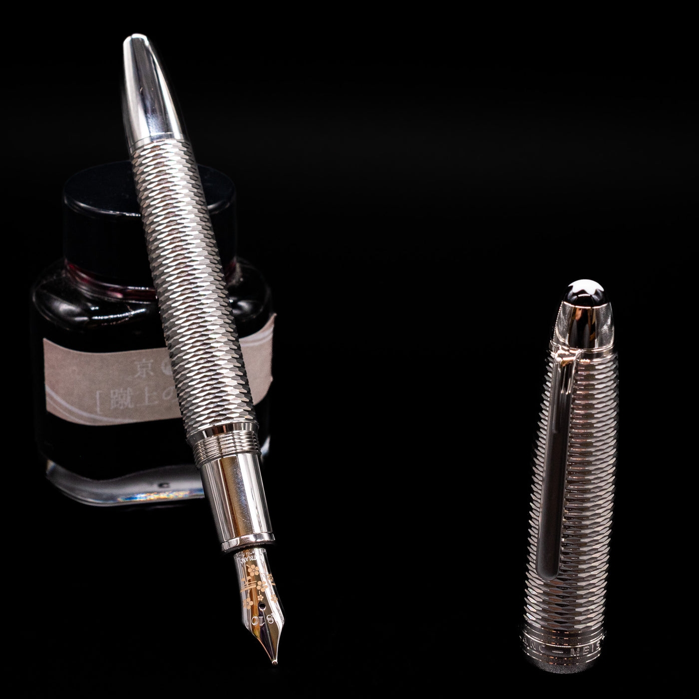 Montblanc Meisterstuck 146 Solitaire Geometry City Edition LeGrand Fountain Pen - Tokyo leaning on an ink bottle uncapped showcasing the detailing on the nib.