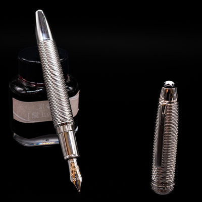 Montblanc Meisterstuck 146 Solitaire Geometry City Edition LeGrand Fountain Pen - Tokyo leaning on an ink bottle uncapped showcasing the detailing on the nib.
