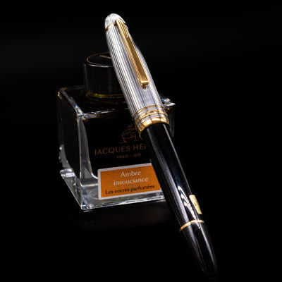 Montblanc Meisterstuck 147DS Solitaire Doue Traveler Fountain Pen - Preowned capped, leaning against an ink bottle. 