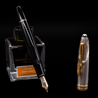 Montblanc Meisterstuck 147DS Solitaire Doue Traveler Fountain Pen - Preowned leaning on an ink bottle uncapped showcasing the detailing on the nib.