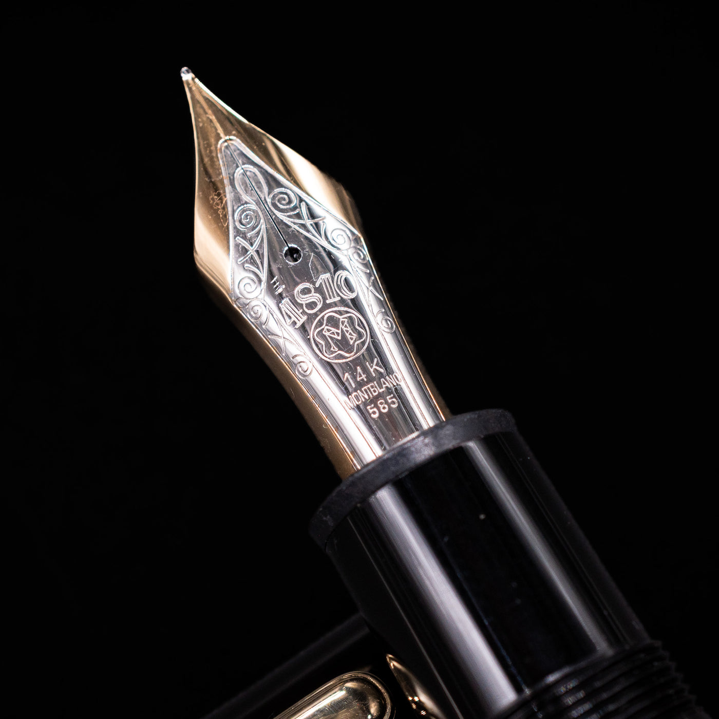 Close-up of the oversized 14k bi-color gold nib on the preowned Montblanc Meisterstück 149 fountain pen, featuring intricate engravings and the Montblanc logo.