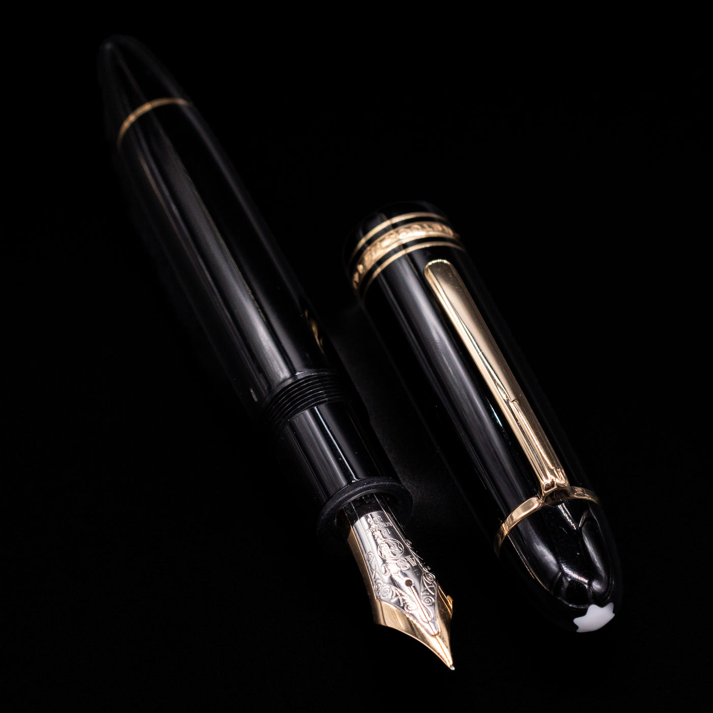Preowned Montblanc Meisterstück 149 fountain pen displayed uncapped, revealing its substantial gold nib, black resin barrel, and gold-plated trim.