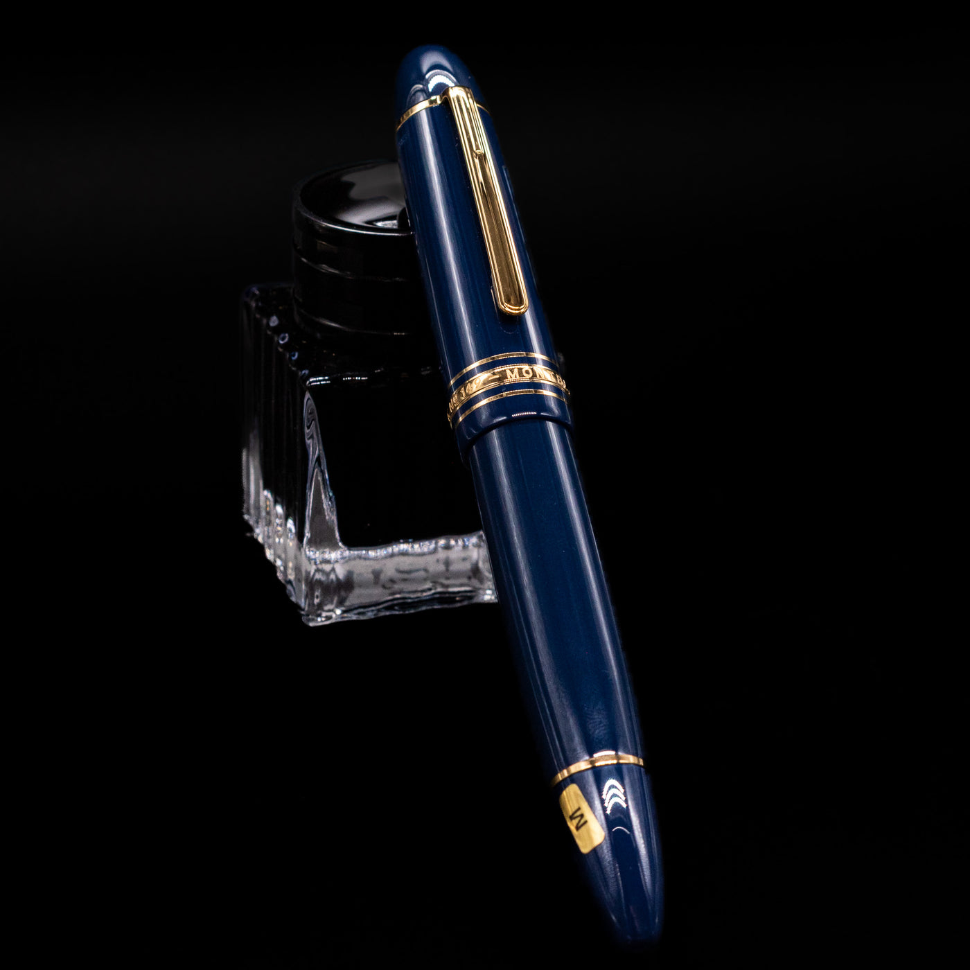 Montblanc Meisterstuck 149 Orient Express Limited Edition 1883 Fountain Pen - Preowned capped, leaning against an ink bottle. 