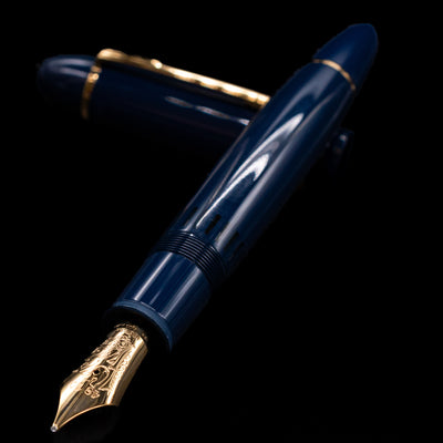 Montblanc Meisterstuck 149 Orient Express Limited Edition 1883 Fountain Pen - Preowned laying across its own cap, crossed, with a focus on the nib.