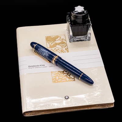 The items including in the Montblanc Meisterstuck 149 Orient Express Limited Edition 1883 Fountain Pen - Preowned box set, a fountain pen, an ink bottle and a notebook.