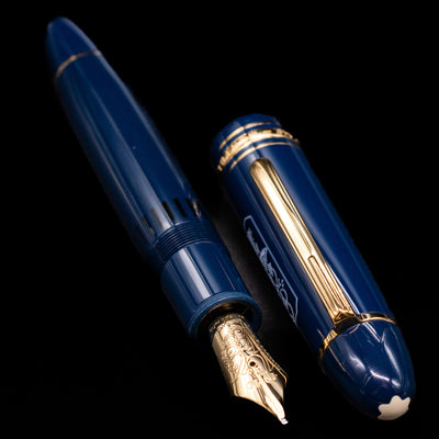 A full view of the Montblanc Meisterstuck 149 Orient Express Limited Edition 1883 Fountain Pen - Preowned uncapped, with its cap laying next to the pen. 