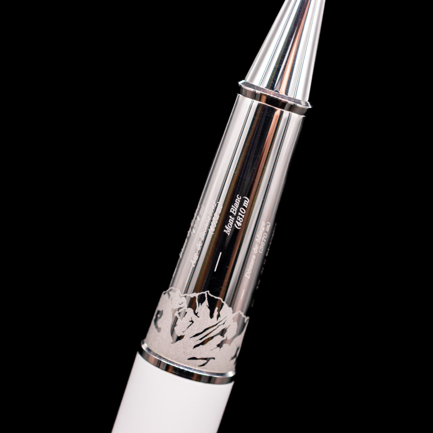 Close-up view of the platinum grip section of the preowned Montblanc Meisterstück 163 Solitaire Tribute to Mont Blanc rollerball pen, showing the smooth metallic finish, the montains detailing, and the connection to the white lacquer barrel.