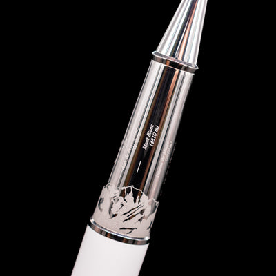 Close-up view of the platinum grip section of the preowned Montblanc Meisterstück 163 Solitaire Tribute to Mont Blanc rollerball pen, showing the smooth metallic finish, the montains detailing, and the connection to the white lacquer barrel.