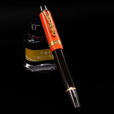 Montblanc Meisterstuck Donation Series Johann Sebastian Bach Fountain Pen - Preowned capped, leaning against an ink bottle. 