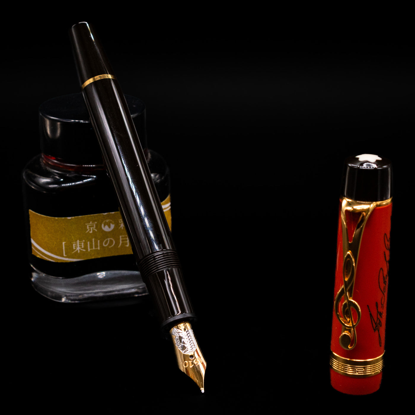 Montblanc Meisterstuck Donation Series Johann Sebastian Bach Fountain Pen - Preowned leaning on an ink bottle uncapped showcasing the detailing on the nib.