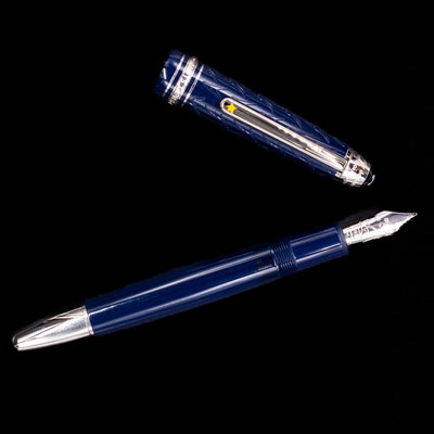 Overhead view of the preowned Montblanc Meisterstück Le Petit Prince Fox LeGrand fountain pen, emphasizing the smooth blue resin cap and platinum clip.