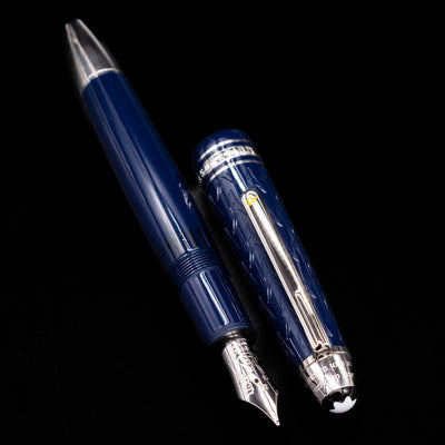 Preowned Montblanc Meisterstück Le Petit Prince Fox LeGrand fountain pen displayed uncapped, showing the blue resin barrel, platinum-plated accents, and engraved gold nib.