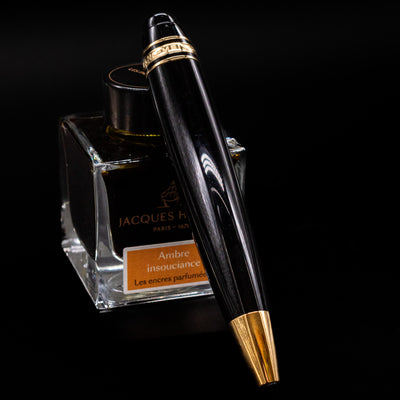 Montblanc Meisterstuck Leonardo Black & Gold Sketch Pencil - Preowned leaning against an ink bottle.