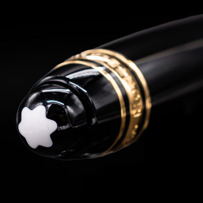 A close-up view of the Montblanc snow cap on top of the cap on the Montblanc Meisterstuck Leonardo Black & Gold Sketch Pencil - Preowned.