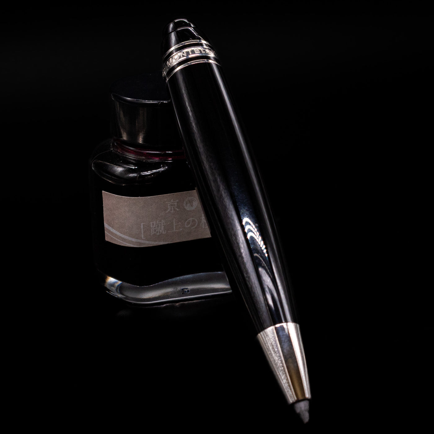 Montblanc Meisterstuck Leonardo Black & Platinum Sketch Pencil - Preowned leaning on an ink bottle.